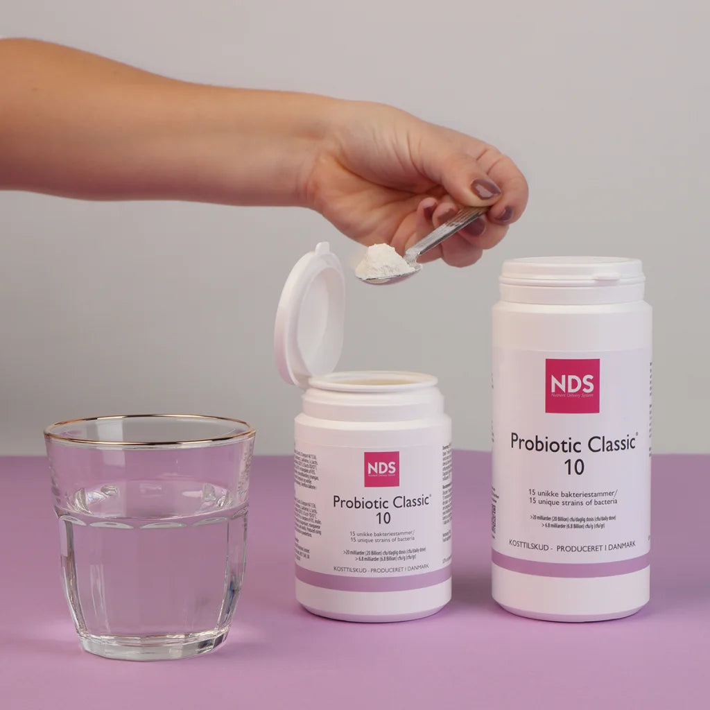 Probiotic in powder form being mixed in water for optimal absorption